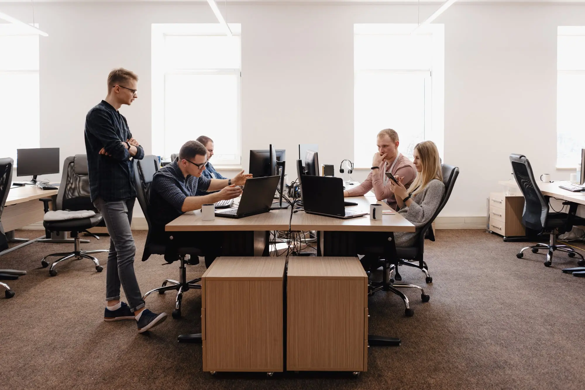 A group of four people working in an office